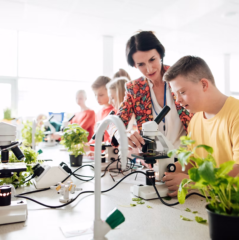 Educator working with students in a classroom setting.